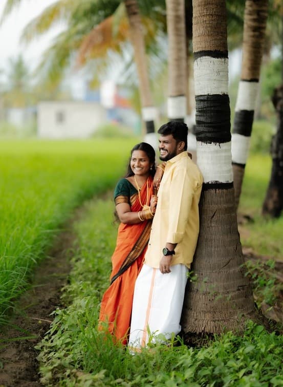 Swetha smiling with wind blowing her veil against the blue sky
